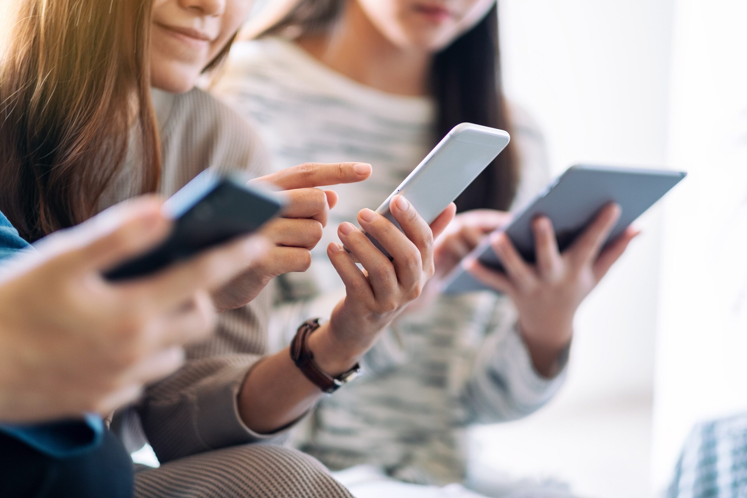 Group of people using and looking at mobile phone and tablet pc